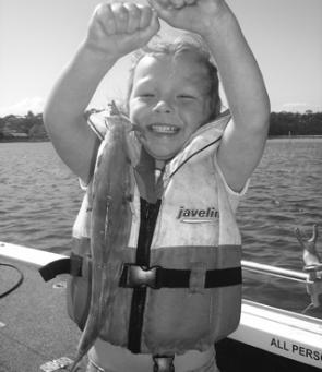 The author’s daughter Jessica, 4, with her trevally caught on a soft plastic.